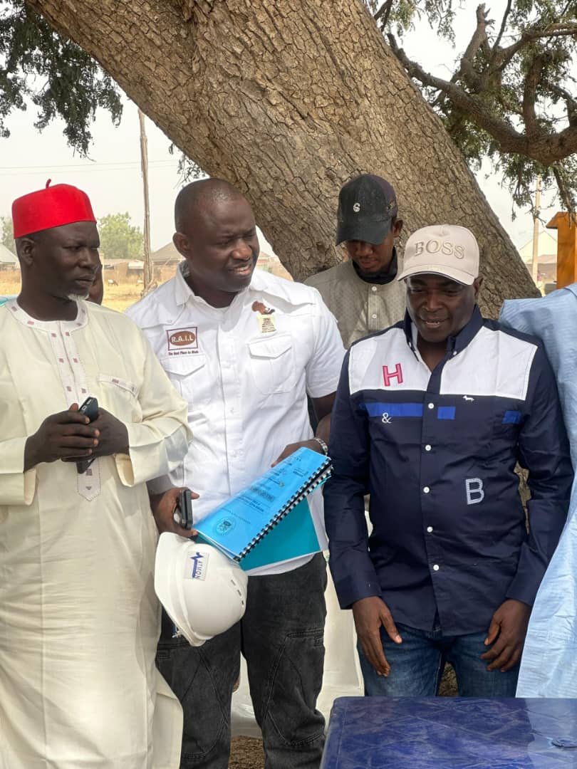 SP Divine Olaniyi Moses reviewing project documents with stakeholders on site